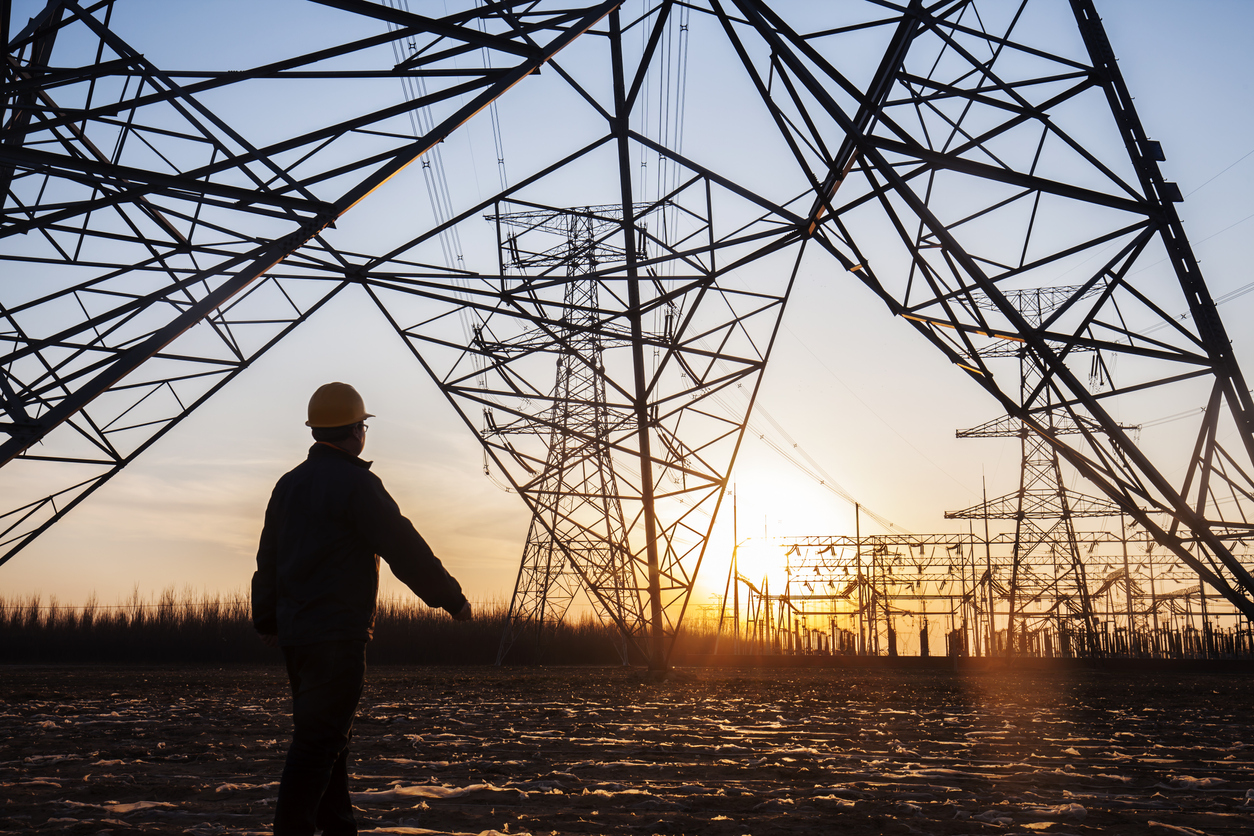 energy workers and pylon silhouette